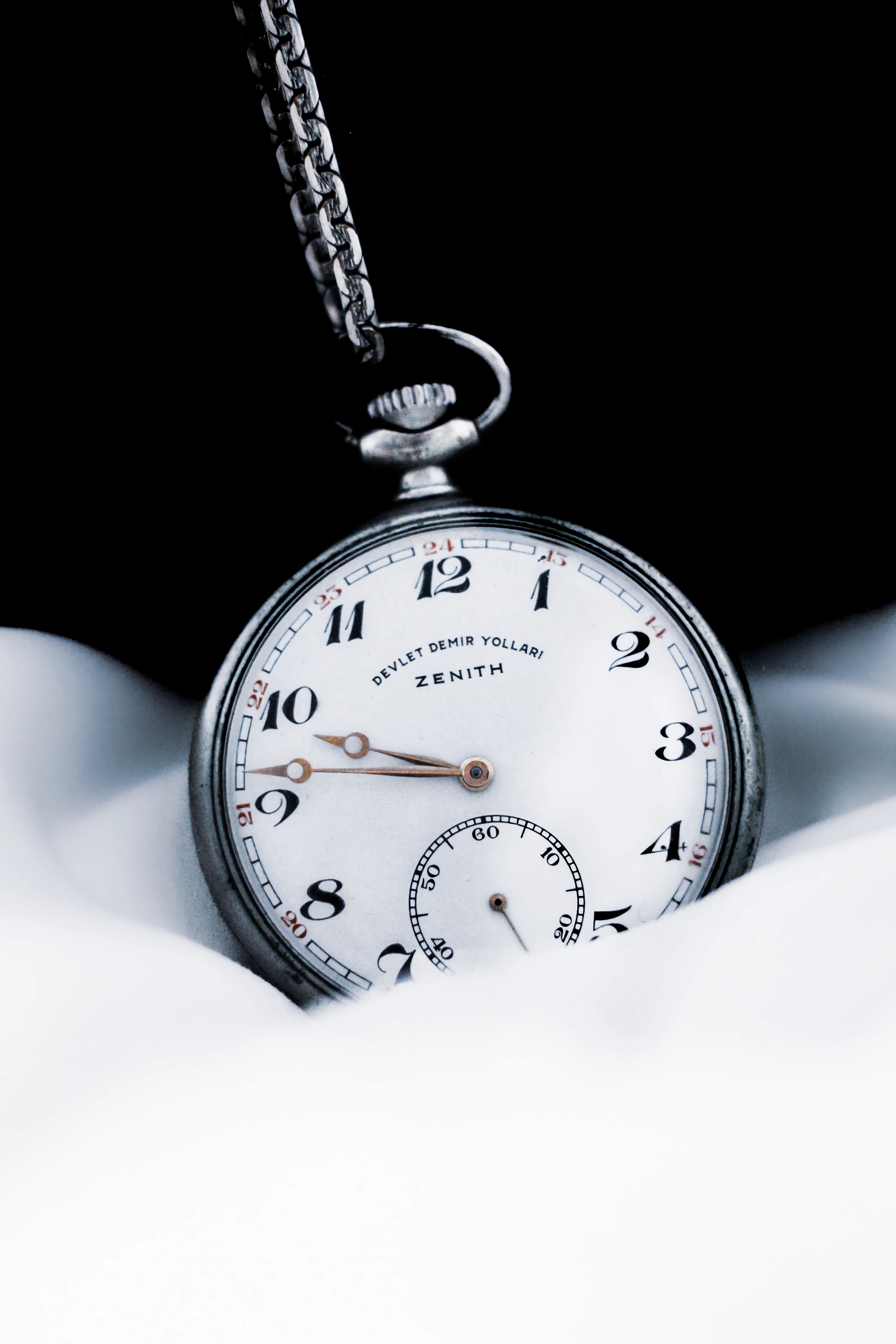 A vintage pocket watch against a dark background